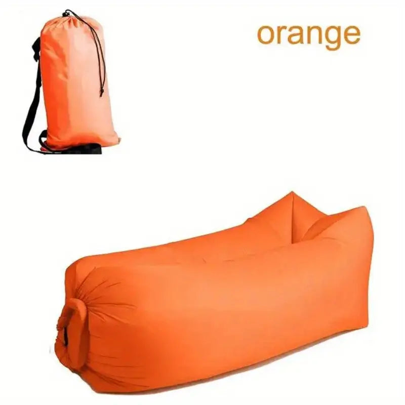Orange inflatable sofa and carrying bag on a white background