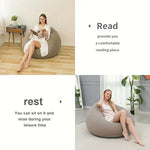 Load image into Gallery viewer, Woman sitting on a bean bag chair in a cozy room, with text indicating its use for reading and relaxation.
